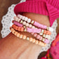 Pink stack of 5 clay and wood beads bracelets in pinks, white and peach