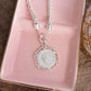 Heirloom Reverie – Ornate Coin Pendant Necklace: Worn Silver Tone